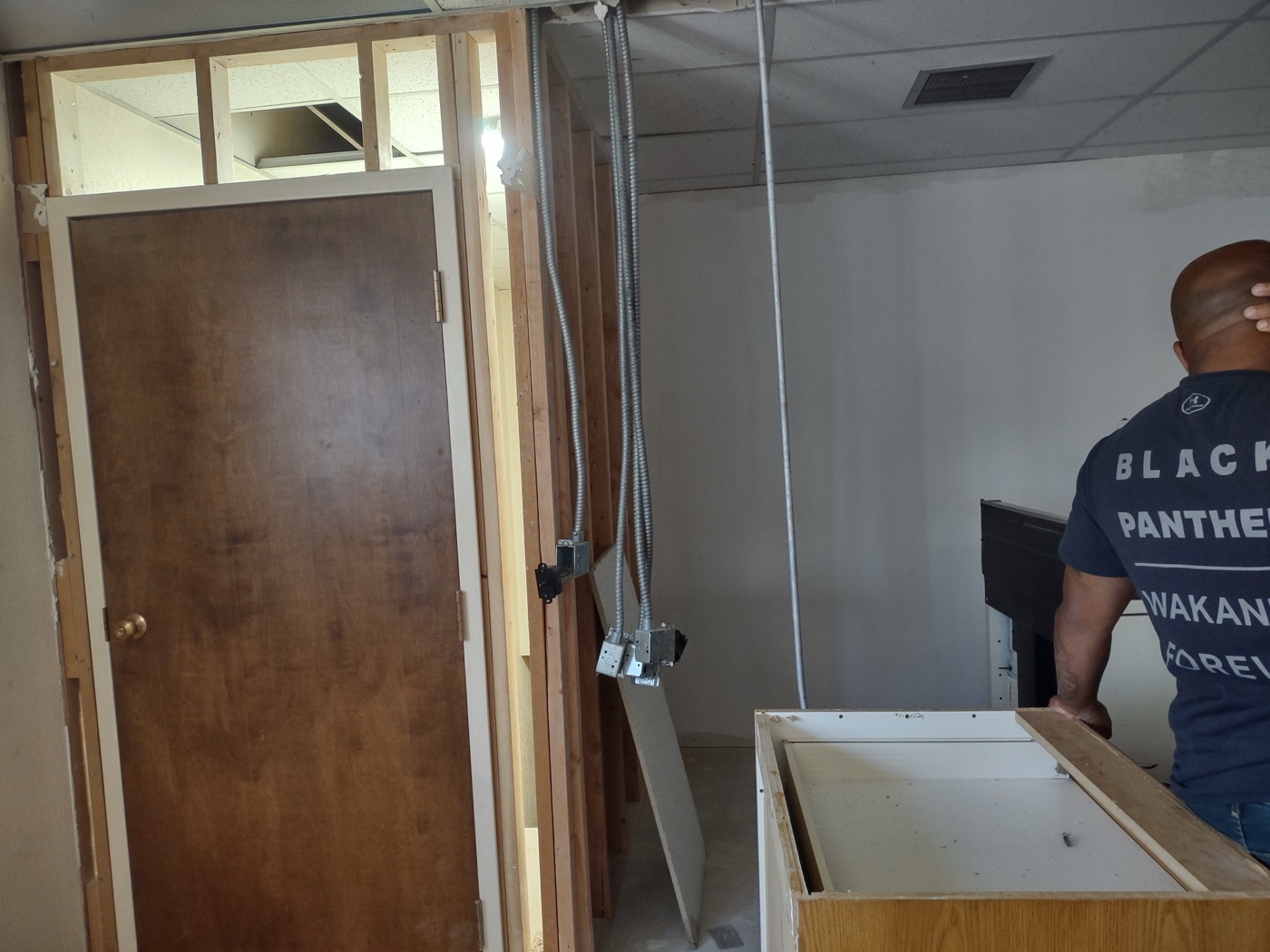 Commercial space mid-demo — electrical conduit relocation and framing exposed